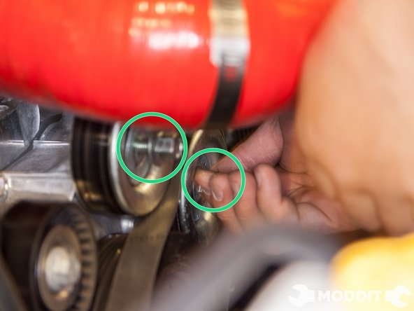 With the 14mm socket, loosen the bolts to both idler pulleys.