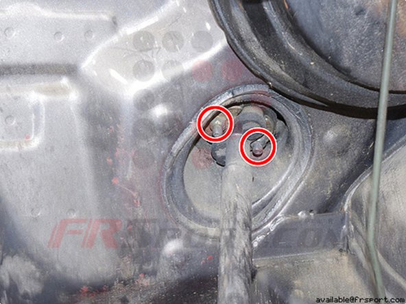 Once the adapter is removed, you will need to remove two 12mm nuts (gold color) holding the bottom half of the steering column from the main portion.