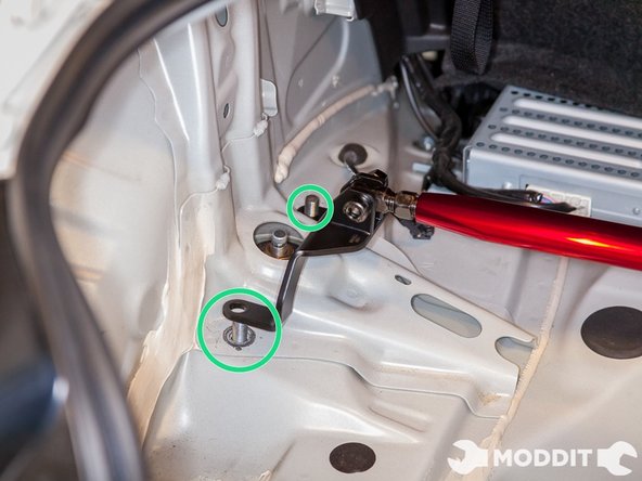 Next, we located the pair of bolts holding in place the rear struts and onto which the strut bar would go on.