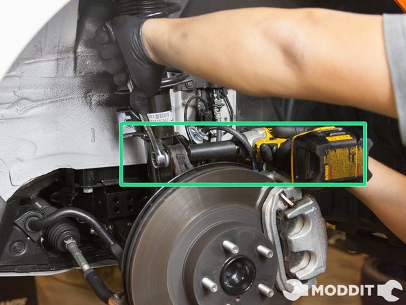 At this point you should find a box, crate, or use the jack (or if you have a friend helping like us, he or she will do) to support the front lower control arm as the whole front oem suspension will soon be disconnected from the stock suspension and fall.