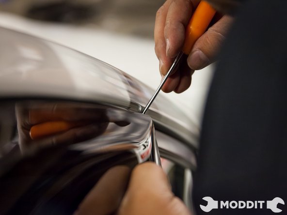 After making sure the clips are in and fastened and the visors are lined up properly, use a pick to remove the tape backing from the visor.