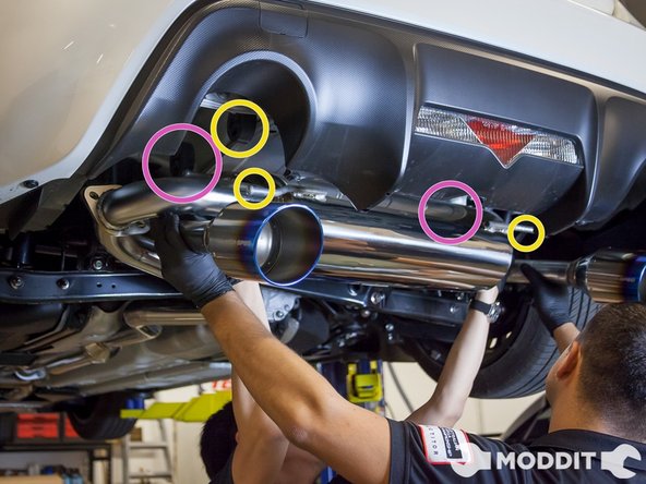 While supporting the muffler, install the front-most (in relationship to the car) exhaust hangers onto the bushing .