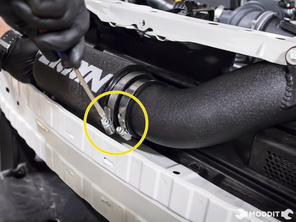 Loosen the clamp holding the intake tube to the throttle body.