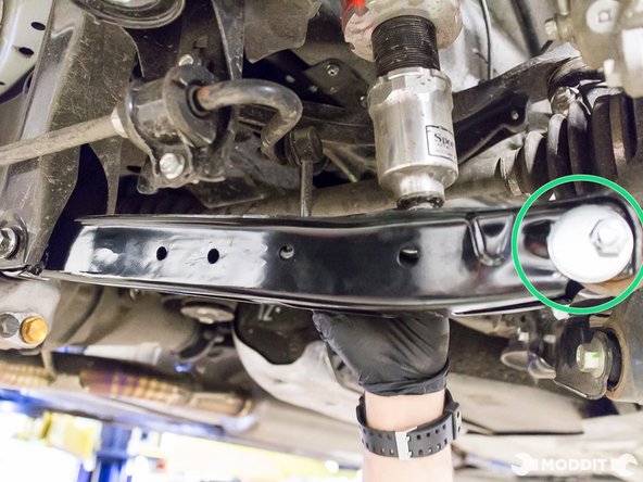 Lay the eccentric disk against the outermost hole of the lower control arm.