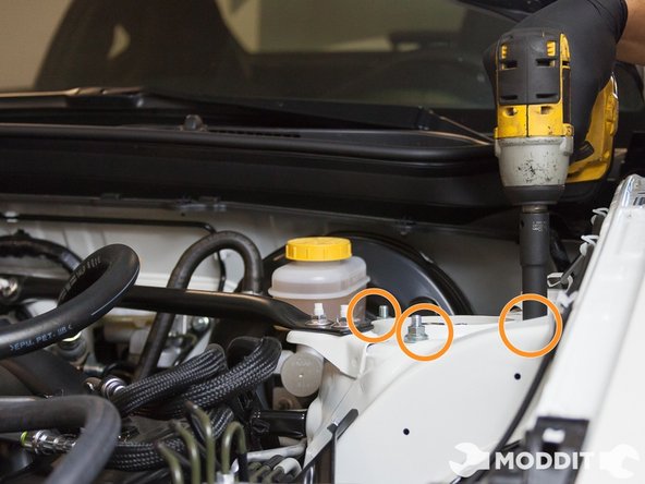 At this point you should find a box, crate, or use the jack (or if you have a friend helping like us, he or she will do) to support the front lower control arm as the whole front oem suspension will soon be disconnected from the stock suspension and fall.