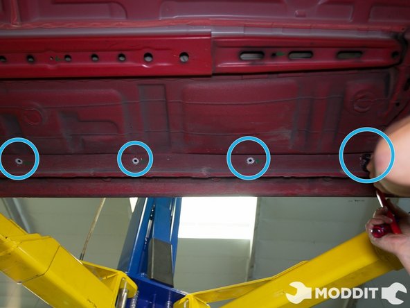 The same technique applies to the Central/Right under tray as the opposite side. Locate all the dampening material clips, remove them, and be sure to use force when removing the clips.