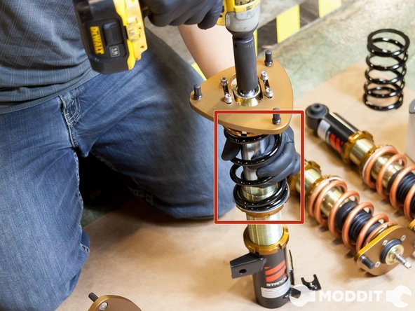 In the images, we show us just using on our hands but then realized that it would be better for the benefit of the coilover to be held with a wrench rather than just our hands.