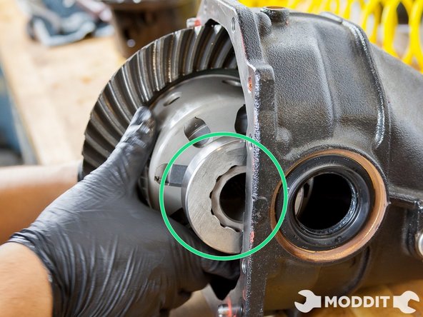 This part is extremely tricky as you will have to hold the bearing covers in place as the differential goes inside of the pumpkin. They will try to move a lot so do your best to keep them in place as the unit goes in.