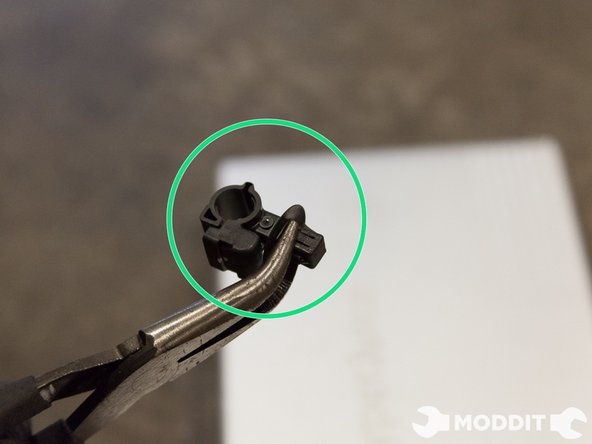 To remove the entire clip from the stock strut in order to reuse on the Stance coilovers, we have to loosen a 4-way clip that is a completely tricky bastard, you have to pinch the larger two prongs, then the smaller two prongs at the same time to remove it.