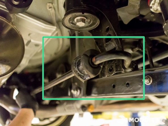 Carefully slide it towards the passenger side of the car and be careful not to damage things on the way out.