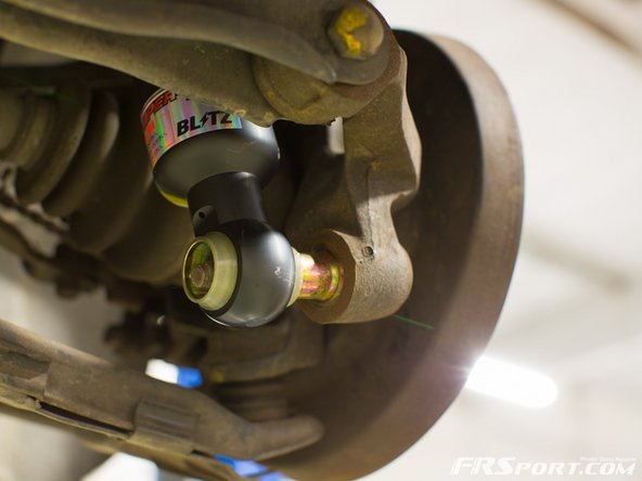 Install top mount into the holes and hand tight the nuts.