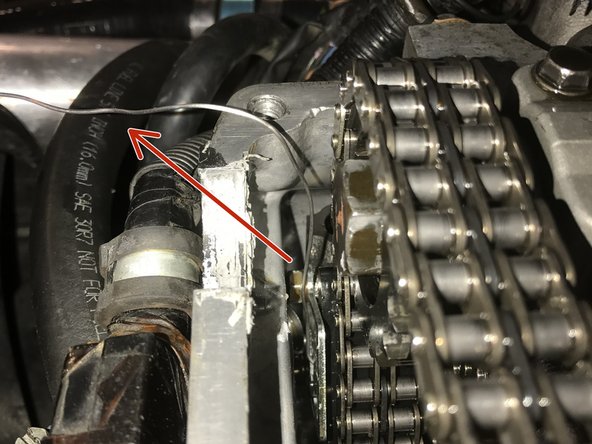 Reinstall the factory upper chain guide if you choose to do so. It is not necessary per the manufacture but it’s up to you. You may now also remove the locking pin holding your tensioner open.