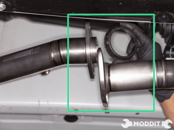Using the factory donut gasket in between the front pipe and the catback, secure but do not tighten Tomei front pipe to catback using factory hardware.