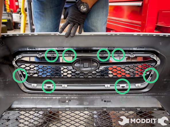 Then locate the 8 push tabs that clips the grill on the bumper.
