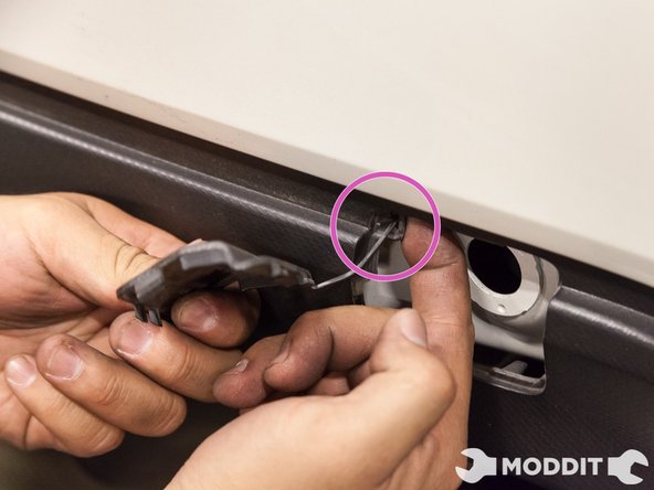 Then use your finger to push out the hook that hangs the cover.