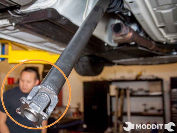 Pry the rear of the driveshaft off the carrier housing using a pry bar.