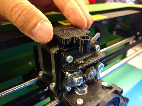 Examine your extruder's filament path for a clean passage. Carefully Peel the back cover off the Velcro square, revealing an adhesive.
