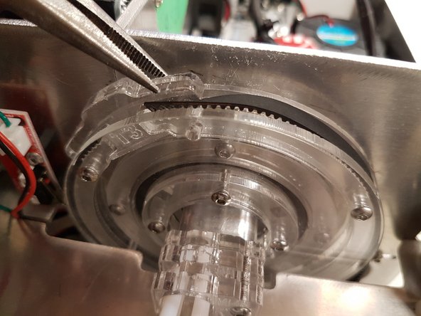 Once the bolt is removed, use your pliers/pinchers to lift up the T-tab in order to slide in the belt.   