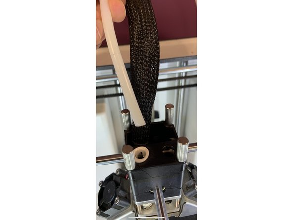 Remove the bowden tube from the print head by removing the lock clip.