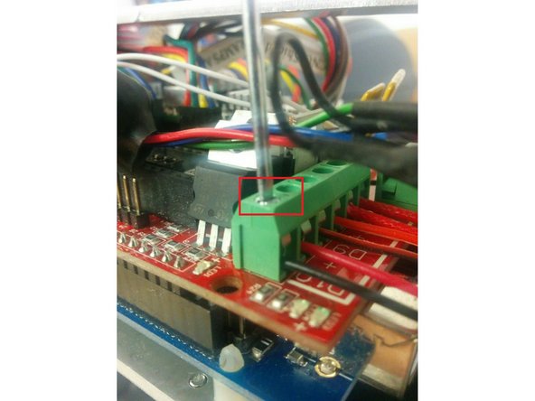 Tighten the screw above the red and black wires to hold them in place.