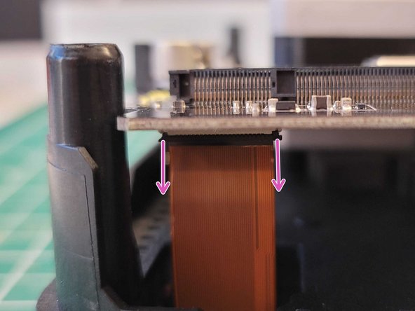Remove screen ribbon cable by lifting the main board slightly, and then pull down on the black tab on the cable connection. This will release the screen cable, which can then be pulled away from the main board.