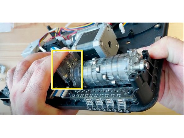 Put the CAM follower piece back into place, such that the small indentations align horizontally with the CAM.