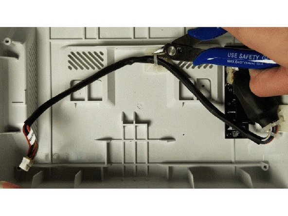 Snip the two zip-ties holding the tether to the bottom casing.