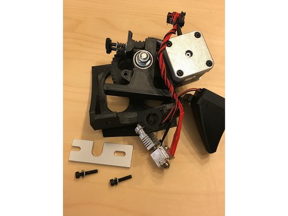 Locate the filament channel in the 3D printed extruder housing, and try to press the upper PTFE sleeve into the channel with the tapered side first. Note the groove in the PTFE tube. Do not apply too much force when trying to insert the PTFE tube. If you run into issues with inserting the PTFE tube, see the following steps.