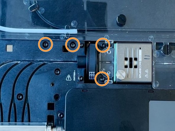 Using the torx screwdriver, remove the two screws holding the cutter wheel assembly and the two screws holding cutter motor.
