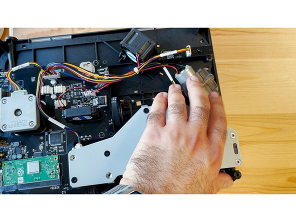 Set the motor aside, and hold the motor in place while flipping the substructure over again to return to the front of the unit.