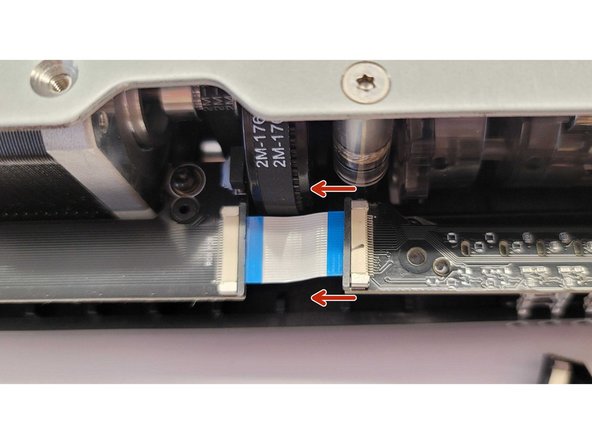 Gently push the black tab on the connector towards the left to release the ribbon cable.