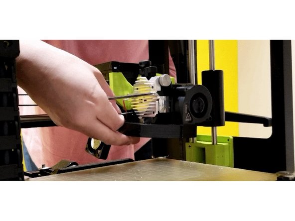 Note: Remember the placement of the shorter screw out of the four. Also, upon unscrewing the last screw on the heat sink, the cooling assembly may drop. Be cautious as the heat sink may come off by itself and the spring from the idler could pop out.