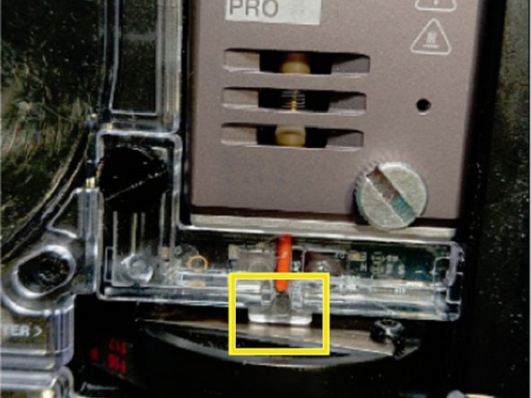 Turn Palette off and rotate the cutter wheel so that one of the screws securing the blade is visible and the plastic notch highlighted in red can be seen. This will allow you to easily remove the acrylic homing switch cover.
