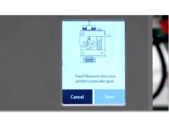 After 2-3 minutes the screen will prompt you to feed filament into your printer's extruder gear. Select 'Next' on the following two screens until you see the screen below that says 'Slowly extrude filament…'.