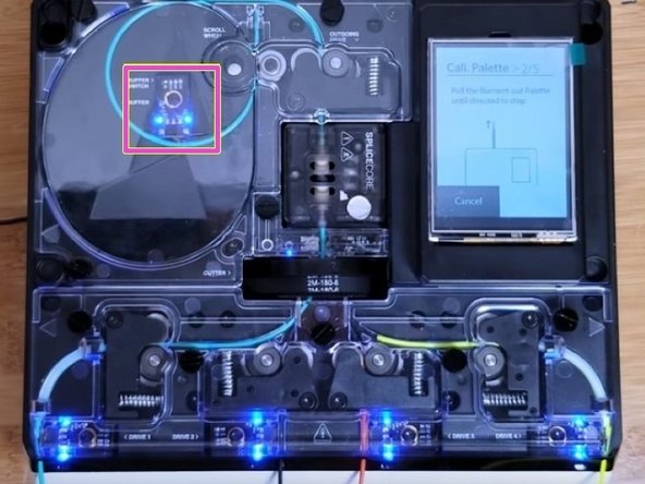 When instructed, gently pull on the filament from the output to activate the buffer. You'll see the lights from the limit switch within the buffer turn on once triggered. Once this is done, Palette 2 will continue to make splices.