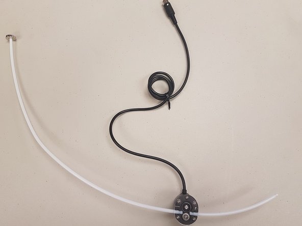 You can now install the shorter Teflon tube into the Scroll Wheel.  Once this is complete, replace the three screws and acrylic plate.