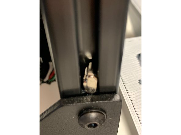 Using the provided 2x  flat head M3 x 7 mm screws and 2x t-nuts from this adaptor kit.  Insert the nuts into the channel sideways, and rotate forward.