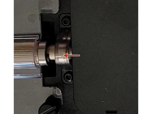 On the right side of the drive gear shaft which is placed near the screen, slide back on the new ingoing drive bracket first, and then the sprocket. Tighten the small set screws back into place.
