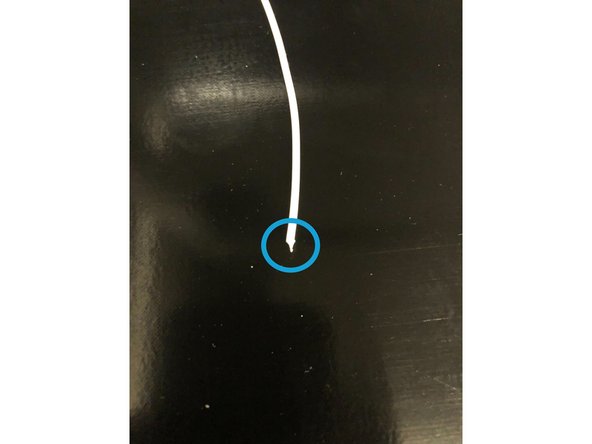 Push the idler down, on the right side of the Print Head, while pulling the filament up. Be careful of hot filament - you can use pliers to pull upwards.