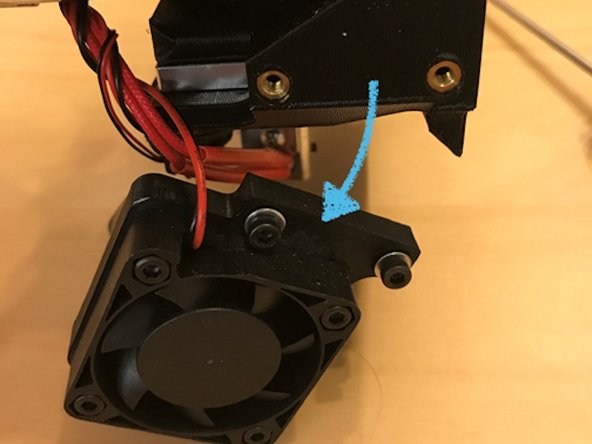 Start by removing the fan from the side of the extruder assembly. This will help us access other bolts.