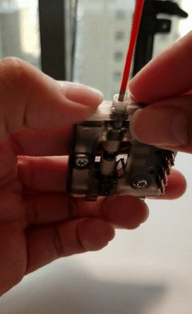 Push the tube out through the tab. Prepare a new Teflon tube by inserting a piece of filament or rod into the Teflon before reinstalling. This will help prevent any buckling or damage to the tubing.