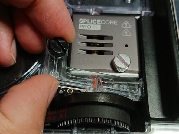 Remove the thumbscrew securing the homing switch acrylic and lift it off.