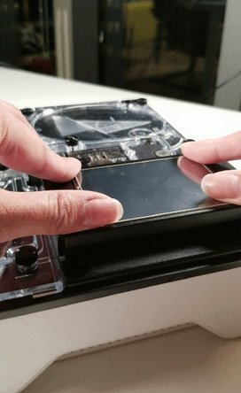 If the screen turns on, proceed to stick the screen back in place. Flip the screen over and remove the protective tape from the adhesive. Place the screen back in its spot and push down to secure the adhesive.