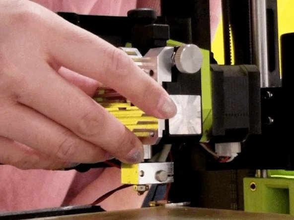 Reinstall the heat sink. Secure the upper left screw first with the red wire. We found that it is easier to attach the red wire to this screw then to the bottom right screw where it originally was. You can choose to do either.