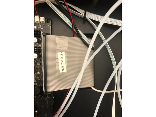 Feed the cables behind the large grey ribbon cable