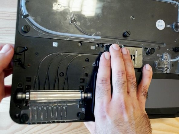 Hold the cutter wheel assembly while flipping the unit to face the bottom of the substructure.