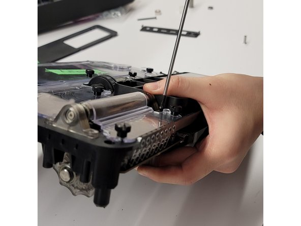 Support the re-assembled CAM caps with your hand to hold it in place, insert the long screws from above and tighten to secure. For the first CAM cap assembly, tighten enough to hold the end piece in place.