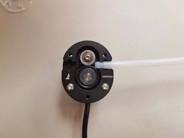 Once the screws and acrylic plate have been removed, you'll be able to lift the left Teflon tube (with no magnet) out of the Scroll Wheel.