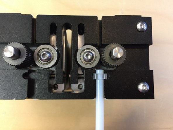 Detach the merger by removing the screw securing Palette+'s clamshell to the cutter.