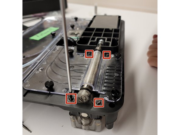 Flip the unit back over to view the top of the unit. Use the Torx screwdriver provided, undo 4x screws on both of the ingoing drive bracket